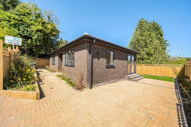 The detached bungalow and its private driveway